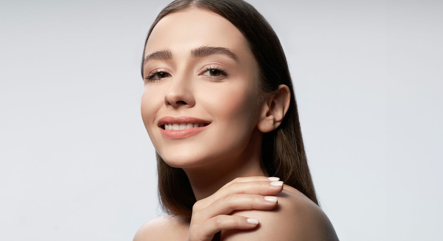 Smiling woman with long hair and soft features